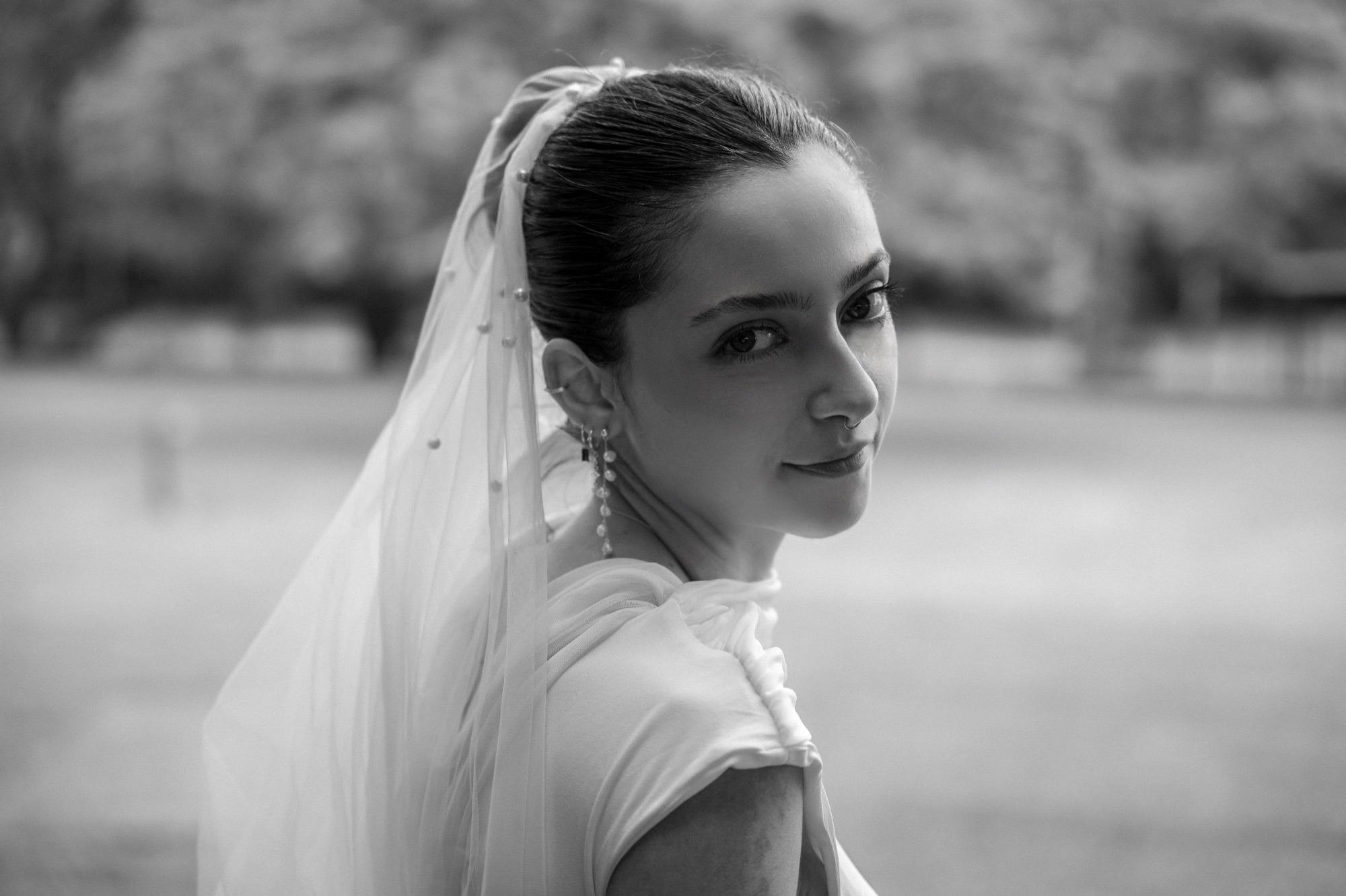 Laura, portrait with veil, looking back