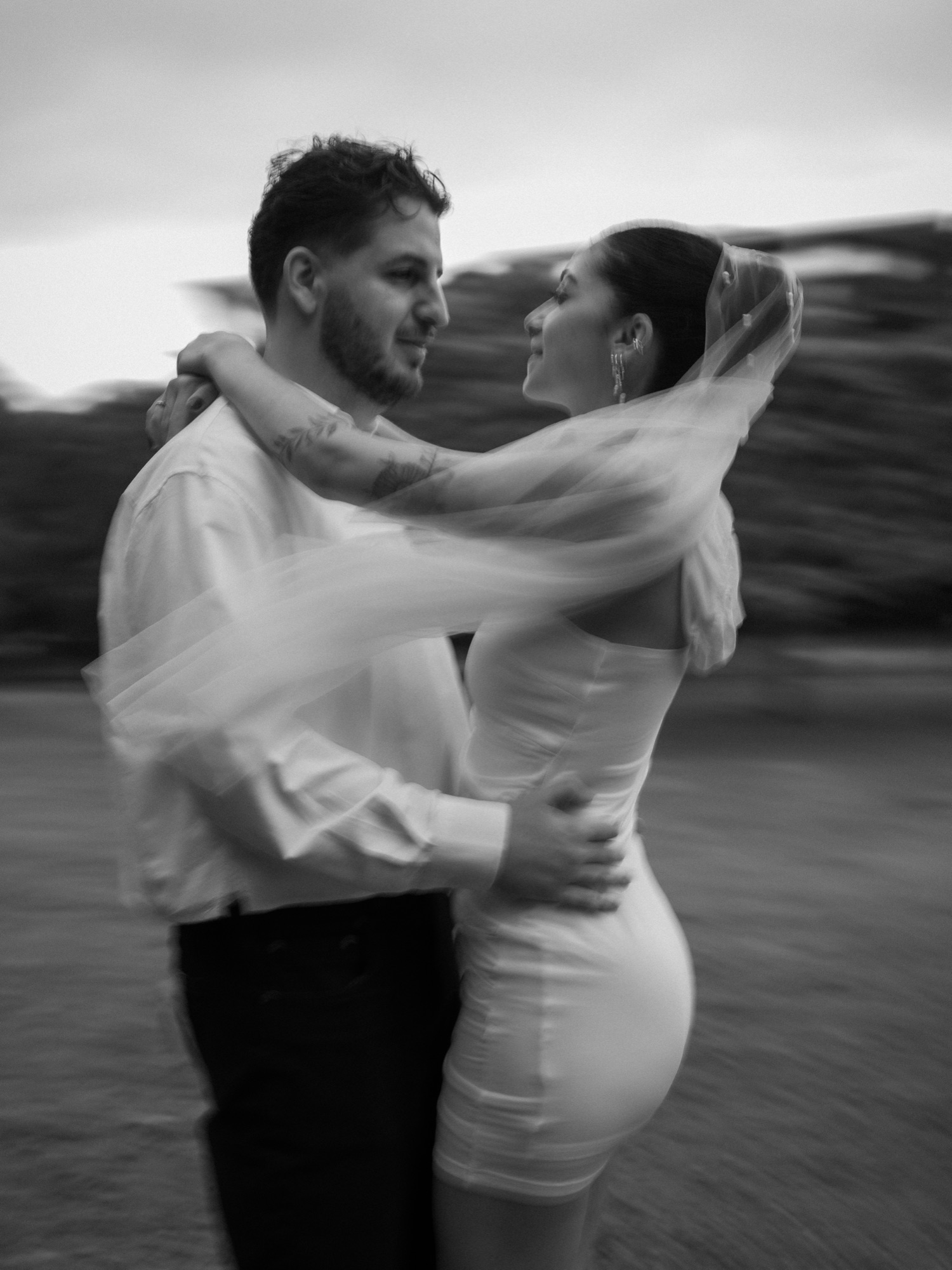 Pre-wedding portrait, couple in embrace with motion blur, black and white